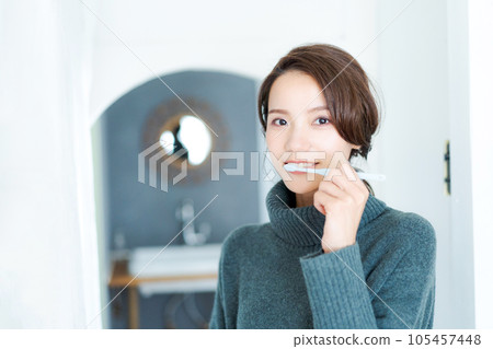 Photo of a woman brushing her teeth 105457448