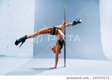 Woman pole dancing 105458175