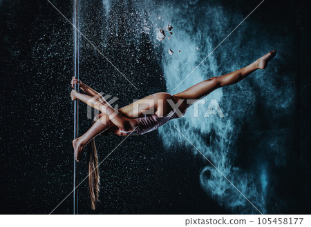 Young woman pole dancing 105458177