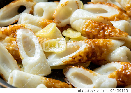 A cooking scene where chikuwa and garlic are fried in a frying pan. A cooking scene where chikuwa and garlic are fried in a frying pan. 105459163