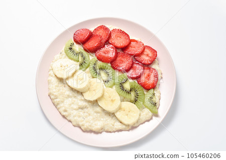 Concept of food for healthy breakfast. oatmeal with bananas, kiwi and strawberry on light background. Top view. Copy space Concept of food for healthy breakfast. oatmeal with bananas, kiwi and strawberry on light background. Top view. Copy space 105460206