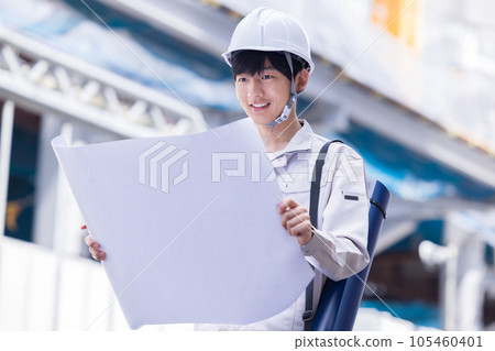 Business A man in work clothes working at a construction site Business A man in work clothes working at a construction site 105460401
