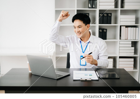 Asian business man are delighted and happy with the work they do on their tablet, laptop and taking notes at the office.. Asian business man are delighted and happy with the work they do on their tablet, laptop and taking notes at the office.. 105460805