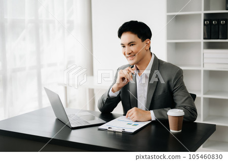 Young business man working at office with laptop, tablet and taking notes on the paper.. 105460830