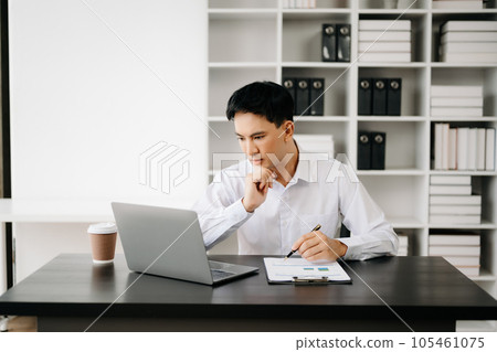 Businessman using tablet and laptop for doing math finance on an office desk, tax, report, accounting, statistics, and analytical research concept in office 105461075