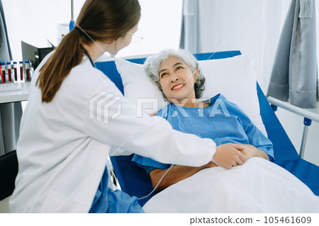 Caucasian doctor smiling take care of a senior patient in hospital. Friendly nurse or therapeutic treat client Professional medical service concept.. 105461609