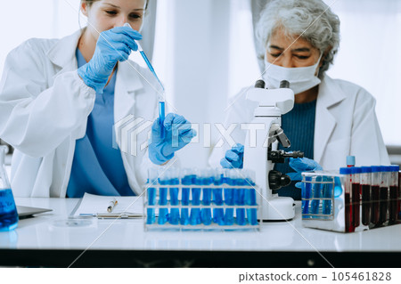 Scientist team meeting and writing analysis results in the laboratory study and analyze scientific sample for global warming, analytics and tech.. 105461828