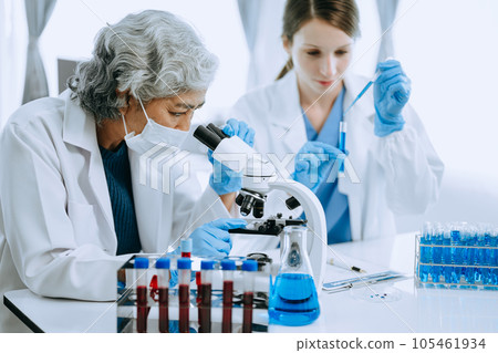 Scientist team meeting and writing analysis results in the laboratory study and analyze scientific sample for global warming, analytics and tech.. 105461934
