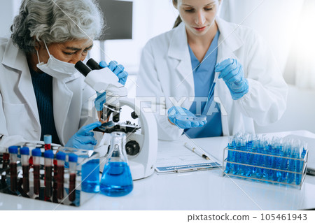 Scientist team meeting and writing analysis results in the laboratory study and analyze scientific sample for global warming, analytics and tech.. Scientist team meeting and writing analysis results in the laboratory study and analyze scientific sample for global warming, analytics and tech.. 105461943
