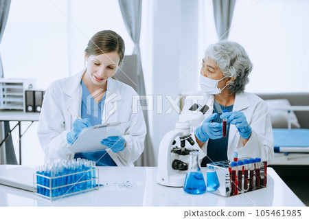 Scientist team meeting and writing analysis results in the laboratory study and analyze scientific sample for global warming, analytics and tech.. 105461985