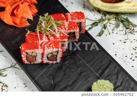 Traditional delicious fresh sushi roll set. Sushi roll with rice, nori, cream cheese, tobiko caviar, avocado. Sushi menu. Traditional delicious fresh sushi roll set. Sushi roll with rice, nori, cream cheese, tobiko caviar, avocado. Sushi menu. 105462702