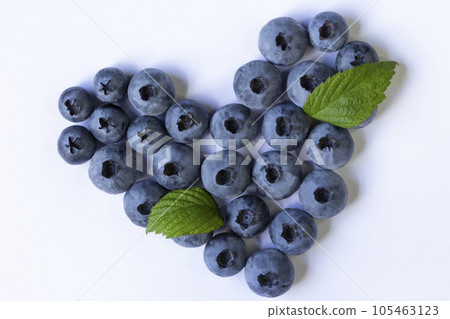 Blueberry with green leaves isolated on white background, heart shape symbol concept for healthy eating and lifestyle Blueberry with green leaves isolated on white background, heart shape symbol concept for healthy eating and lifestyle 105463123