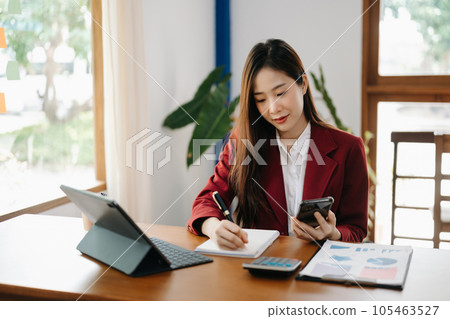 Asian woman working in the office with working notepad, tablet and laptop documents 105463527