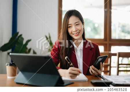 Asian woman working in the office with working notepad, tablet and laptop documents 105463528