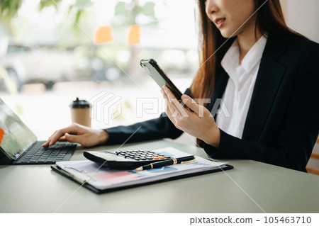 businesswoman or accountant hand typing laptop working to calculate on desk about cost at home office.. businesswoman or accountant hand typing laptop working to calculate on desk about cost at home office.. 105463710