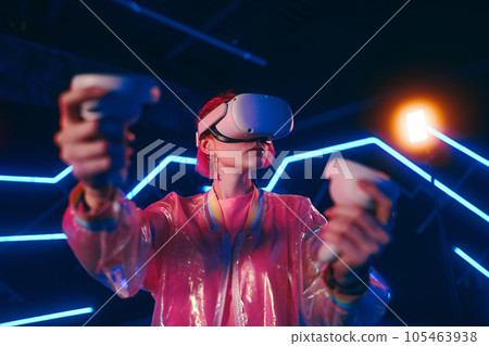 A young woman plays virtual games. Neon room for vr games. 105463938