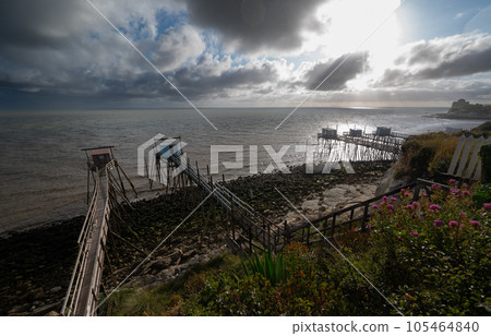 Traditional fisherman's wooden hut at the bottom of the limestone cliff in the estuary of Gironde Traditional fisherman's wooden hut at the bottom of the limestone cliff in the estuary of Gironde 105464840