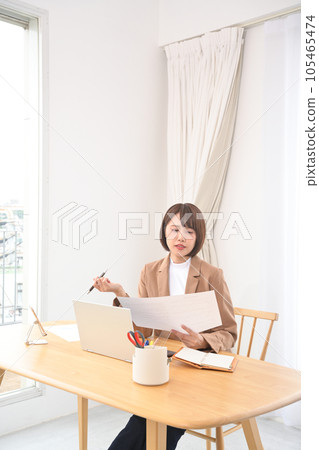Woman doing desk work indoors 105465474