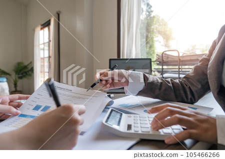Teamwork of business two colleagues analysis with financial data and marketing report graph, Young business woman two co worker discussing for calculating financial document with calculator Teamwork of business two colleagues analysis with financial data and marketing report graph, Young business woman two co worker discussing for calculating financial document with calculator 105466266
