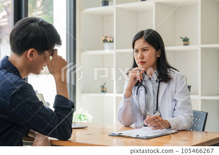 Young asian woman doctor consulting asian worried patient patient on room in hospital, friendly female physician practitioner talking, giving recommendation, discussing checkup or symptoms Young asian woman doctor consulting asian worried patient patient on room in hospital, friendly female physician practitioner talking, giving recommendation, discussing checkup or symptoms 105466267