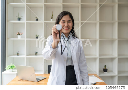 Portrait of asian female doctor smiling while using stethoscope Portrait of asian female doctor smiling while using stethoscope 105466275