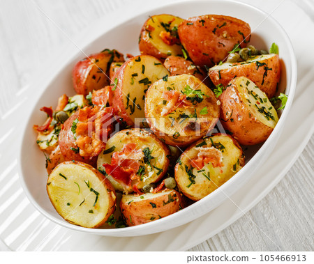 Herbs Garlic Potatoes in white bowl, top view Herbs Garlic Potatoes in white bowl, top view 105466913