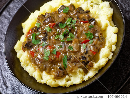 potato mash topped with mushroom gravy in bowl potato mash topped with mushroom gravy in bowl 105466914