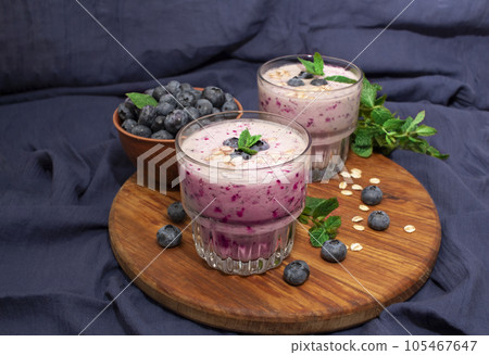 Homemade blueberry smoothie with mint on a blue fabric background. Detox diet Homemade blueberry smoothie with mint on a blue fabric background. Detox diet 105467647