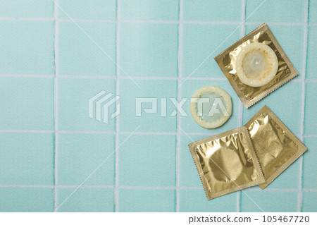 Condoms on a blue background, place for text 105467720