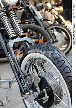 Classic White Wall Tire On The Front Wheel Of Custom Motorcycle Classic White Wall Tire On The Front Wheel Of Custom Motorcycle 105467780