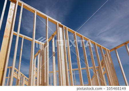 Construction frame house of wooden beam stick framework on new build home Construction frame house of wooden beam stick framework on new build home 105468149