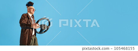 Banner of angry balded and mustache driver throwing purse over blue studio background. 105468155