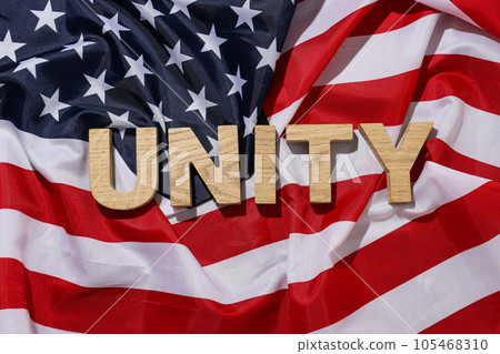 American flag with the word "unity" in wooden letters 105468310