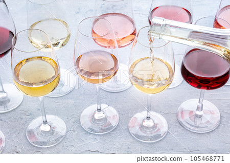 White wine pour into a glass at a tasting. Rose, red, and white wines 105468771