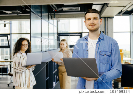 A guy with a laptop in his hands in the office 105469324