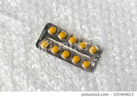blister pills medicine. medical treatment for disease flu virus. A blister of soft beige pills in the middle on white bubble background Monochrome simple flat lay Trendy minimalistic. Selective focus 105469623