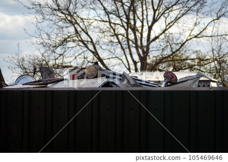 Pile of scrap metal in the backyard in a neat tank. Metal recycling. Second life to things. Caring for the environment. Conscious metal consumers. Selective focus. 105469646