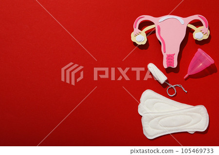 Means of feminine hygiene during menstruation, on a red background 105469733