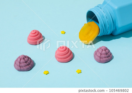 Jelly candies and blue jar on blue background 105469802