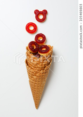 Jelly candies in waffles cones on white background, top view 105469803