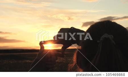 sign photo video frame, girl shows hands fingers sunset frame, family dream happiness journey, amazing beautiful sunset, girl park making hand gesture frame by sunset summer, vision strategy concept 105469868