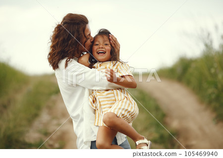 Family in a summer field. Sensual photo. Cute little girl. Family in a summer field. Sensual photo. Cute little girl. 105469940
