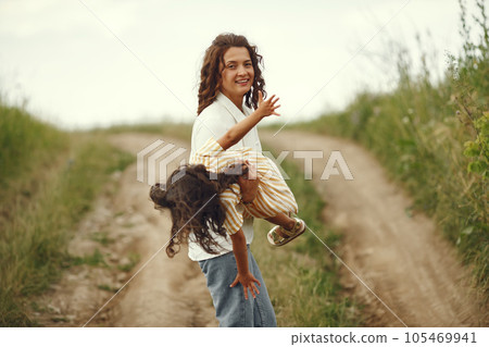 Family in a summer field. Sensual photo. Cute little girl. 105469941