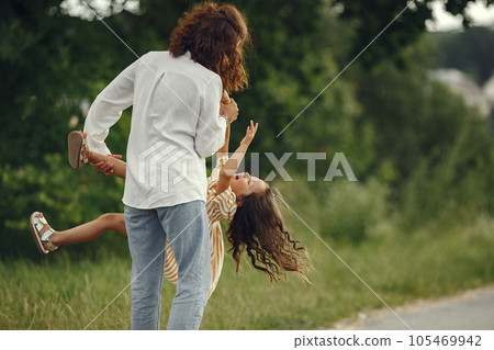 Family in a summer field. Sensual photo. Cute little girl. 105469942