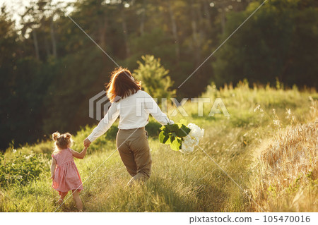 Family in a summer field. Sensual photo. Cute little girl. Family in a summer field. Sensual photo. Cute little girl. 105470016