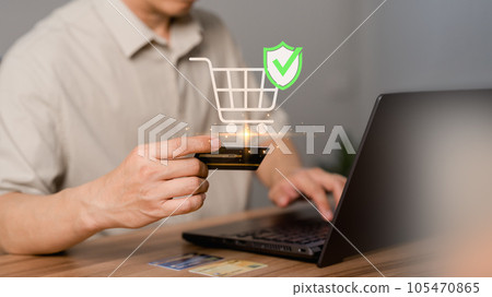 A customer uses a laptop computer to register through a credit card to make online purchases. Business concept of credit card shopping online, paying bills online, and various payments. 105470865