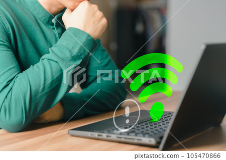 Adult man using a computer laptop to connect to wifi in his home but wifi not working, and waiting to load digital game data from the website, concept technology of waiting to connect to wifi. 105470866