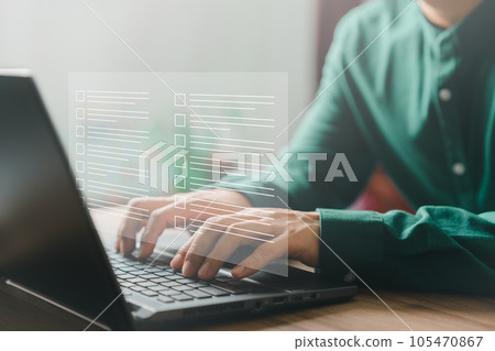 Adult man using laptop computer with virtual screen contact questionnaire with checkbox. Assessment knowledge test concept, fill out application form, online exam, quiz knowledge and online learning. 105470867