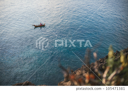 Fisherman on a boat in the ocean 105471381
