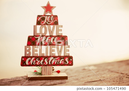Wooden christmas tree toy on the beach Wooden christmas tree toy on the beach 105471490